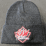 A raw customs beanie hat with the logo on it.