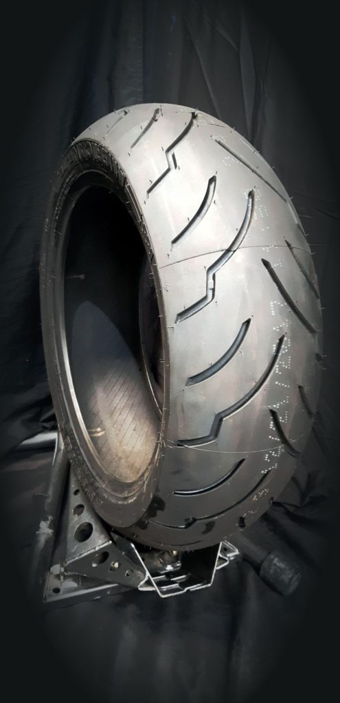 A close up of the tire on a motorcycle