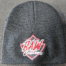 A raw customs beanie hat with the logo on it.
